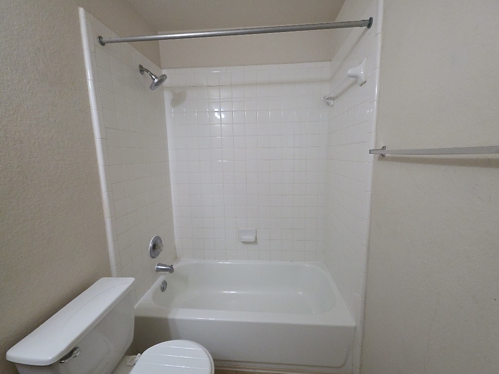 210 Delby Street Hutto, TX 78634 - Photo 11 of 15 a bathroom with a shower and a toilet