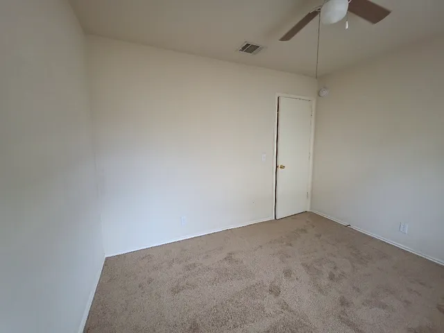 a view of an empty room with a fan