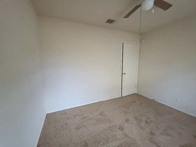 a view of an empty room with a fan