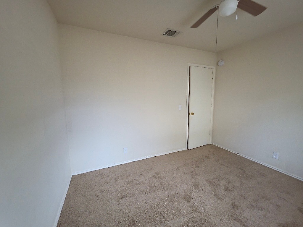 210 Delby Street Hutto, TX 78634 - Photo 12 of 15 a view of an empty room with a fan