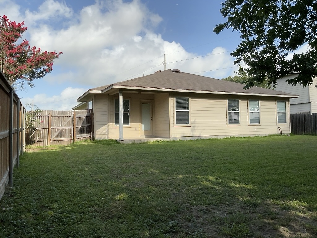 210 Delby Street Hutto, TX 78634 - Photo 14 of 15 a front view of a house with a garden