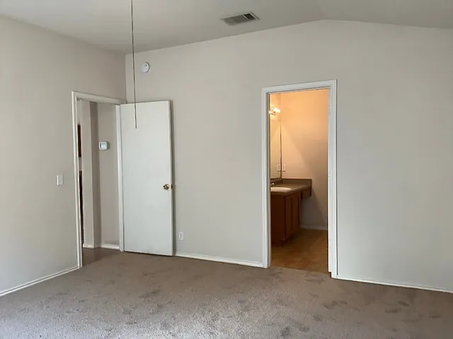 a view of a big room with closet and a hallway