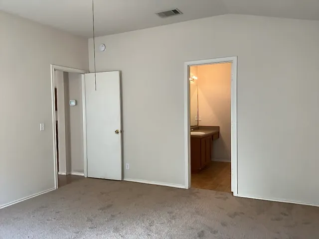 a view of a big room with closet and a hallway