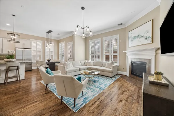 a living room with furniture kitchen and a chandelier