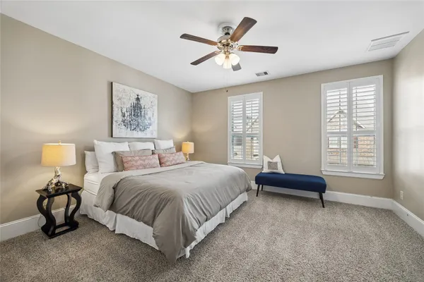 a view of a livingroom with a ceiling fan and window