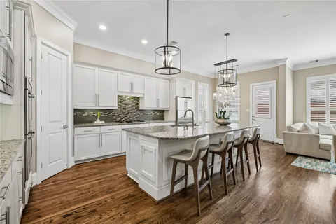 a living room with furniture a rug and a flat screen tv