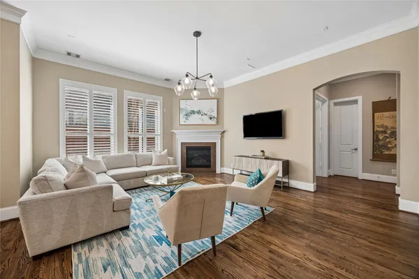 a dining room with furniture a chandelier and wooden floor