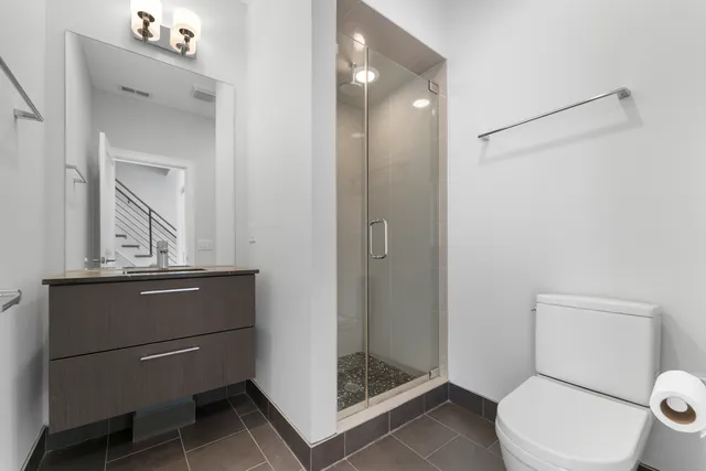 a bathroom with a toilet a sink and shower