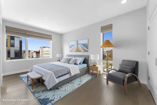 a spacious bedroom with a bed and a couch