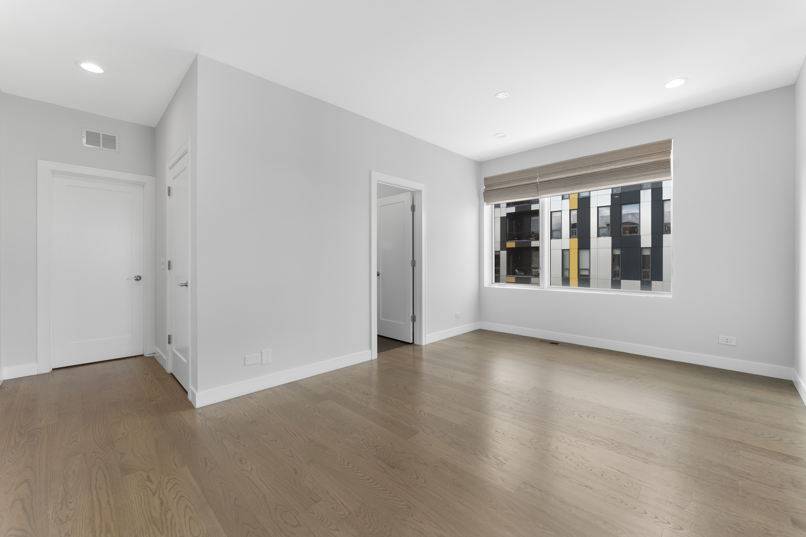 1555 North Talman Avenue, Unit 3F Chicago, IL 60622 - Photo 20 of 37 an empty room with wooden floor and windows