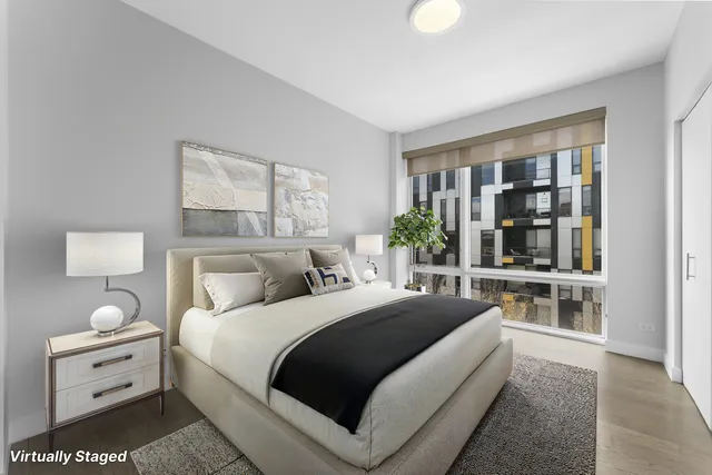 a bedroom with a large bed and a window