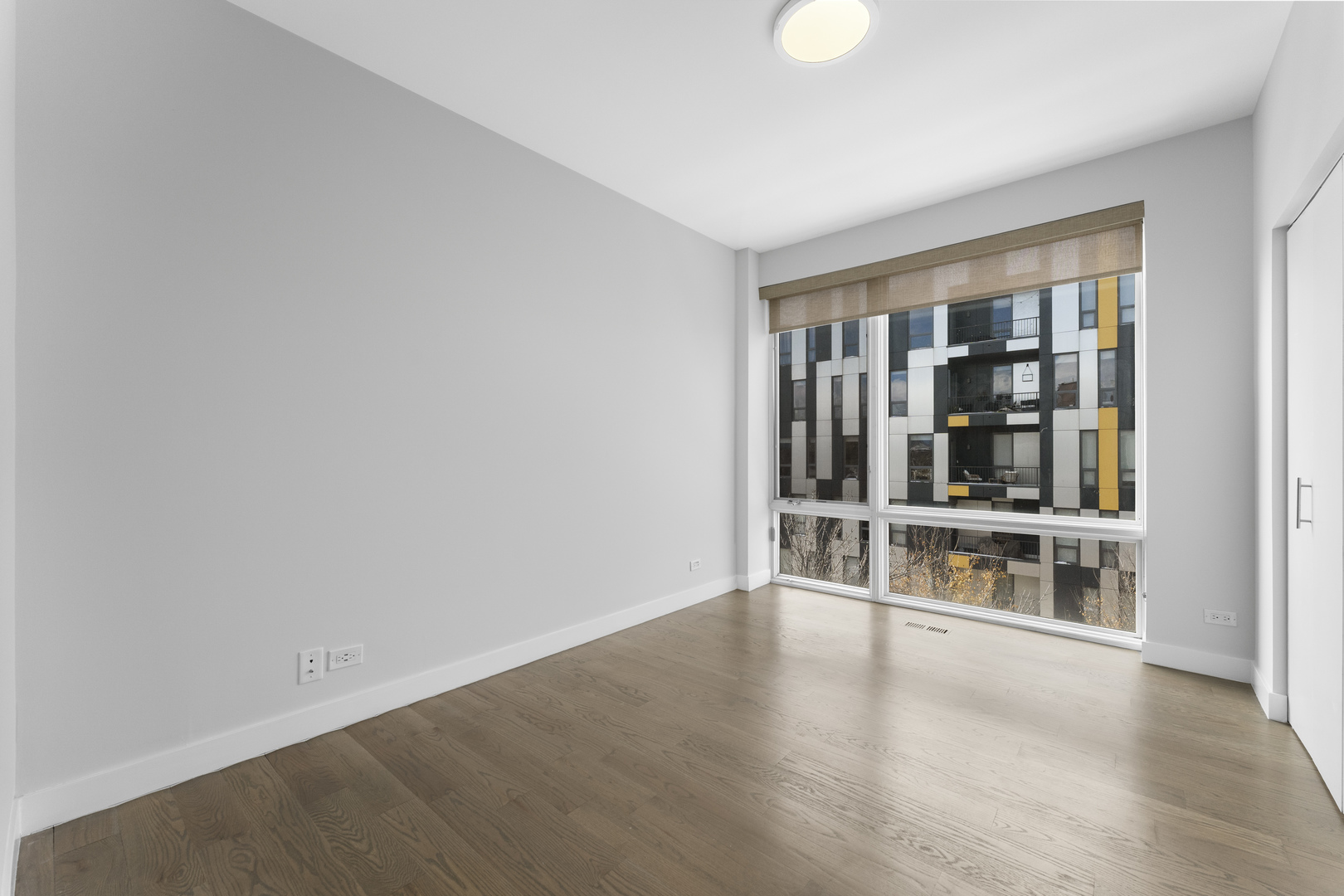 1555 North Talman Avenue, Unit 3F Chicago, IL 60622 - Photo 27 of 37 wooden floor in an empty room with a window