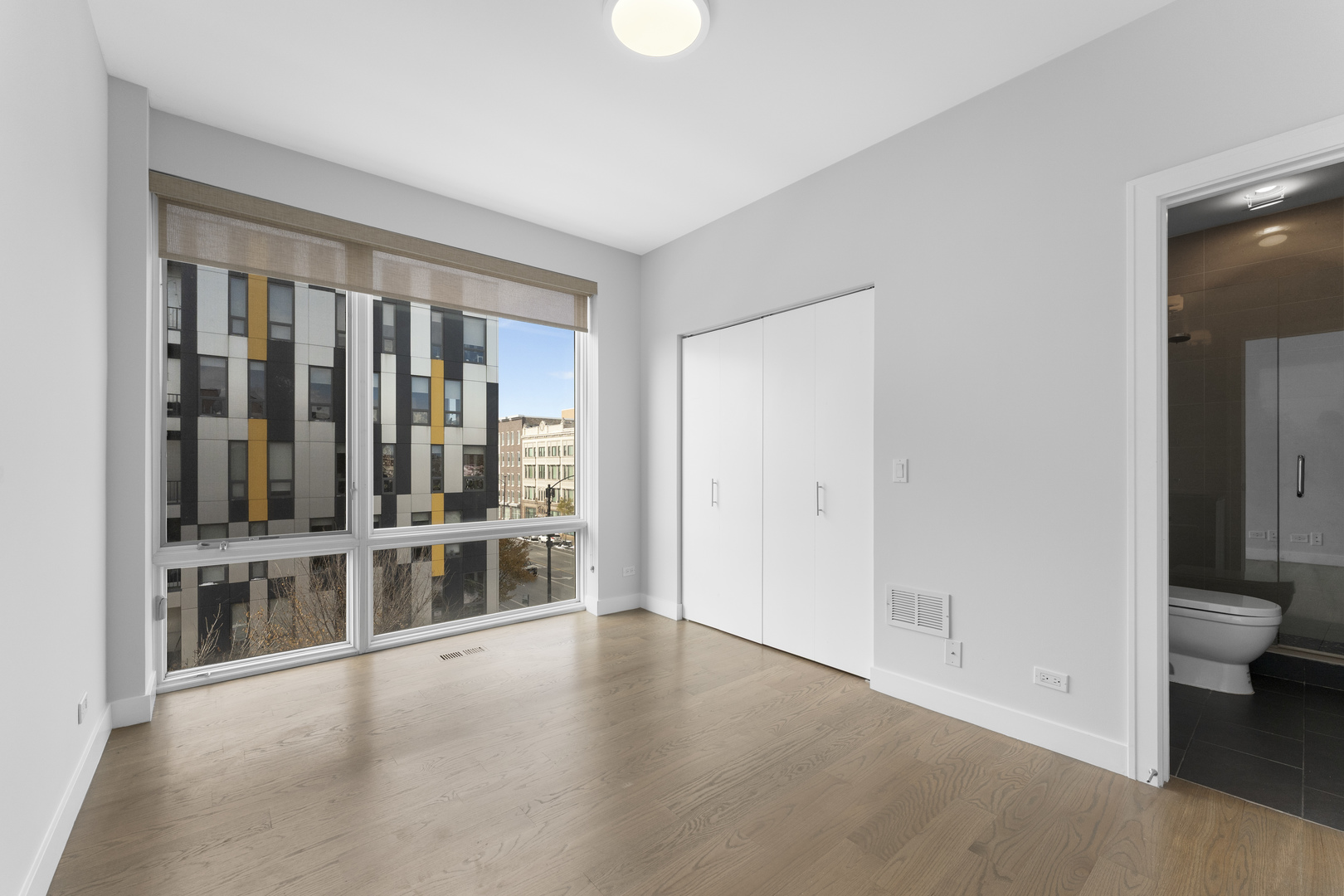 1555 North Talman Avenue, Unit 3F Chicago, IL 60622 - Photo 28 of 37 wooden floor in an empty room with a window