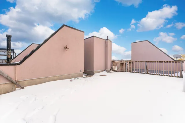 a view of a house with a snow in the background