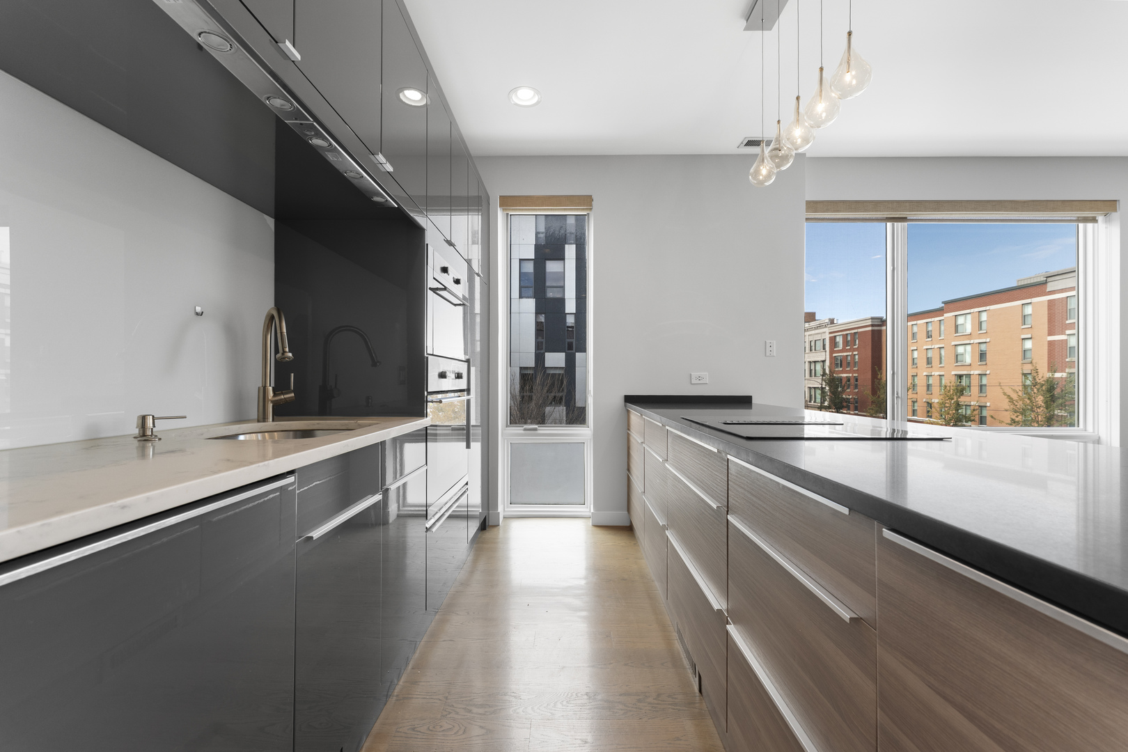 1555 North Talman Avenue, Unit 3F Chicago, IL 60622 - Photo 10 of 37 a large kitchen with a large counter top a sink stainless steel appliances and cabinets