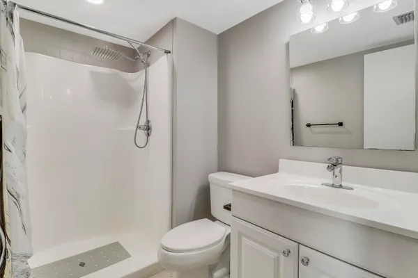 a bathroom with a sink toilet and shower