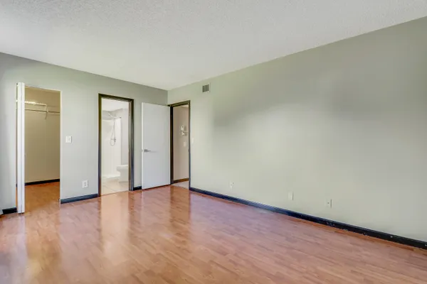 a view of an empty room and wooden floor