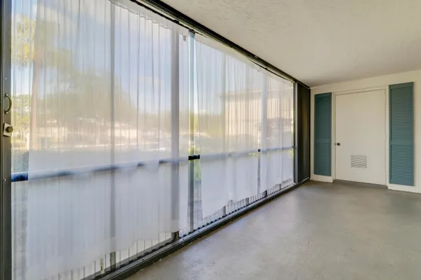 a view of a entrance and room with windows