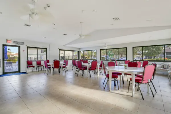 a view of a dining area with furniture and a large window