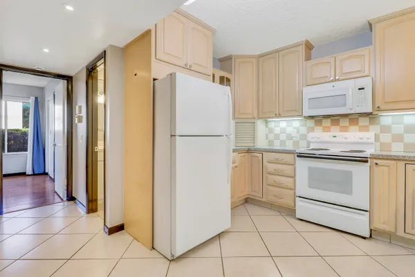 a white refrigerator freezer sitting in a kitchen