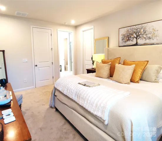 a spacious bedroom with a bed and a window