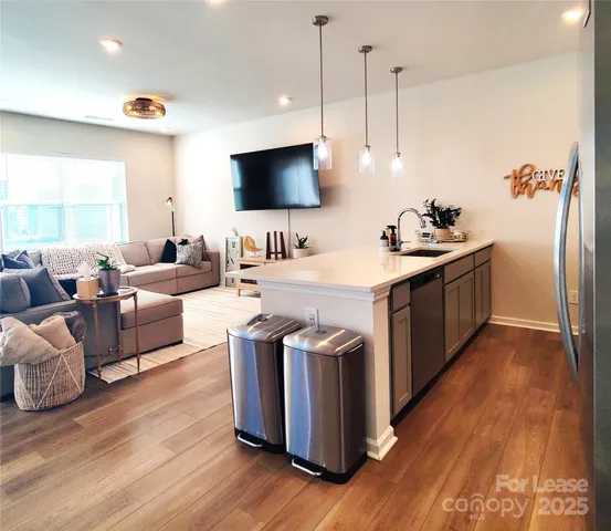 a kitchen with stainless steel appliances granite countertop a sink and a stove