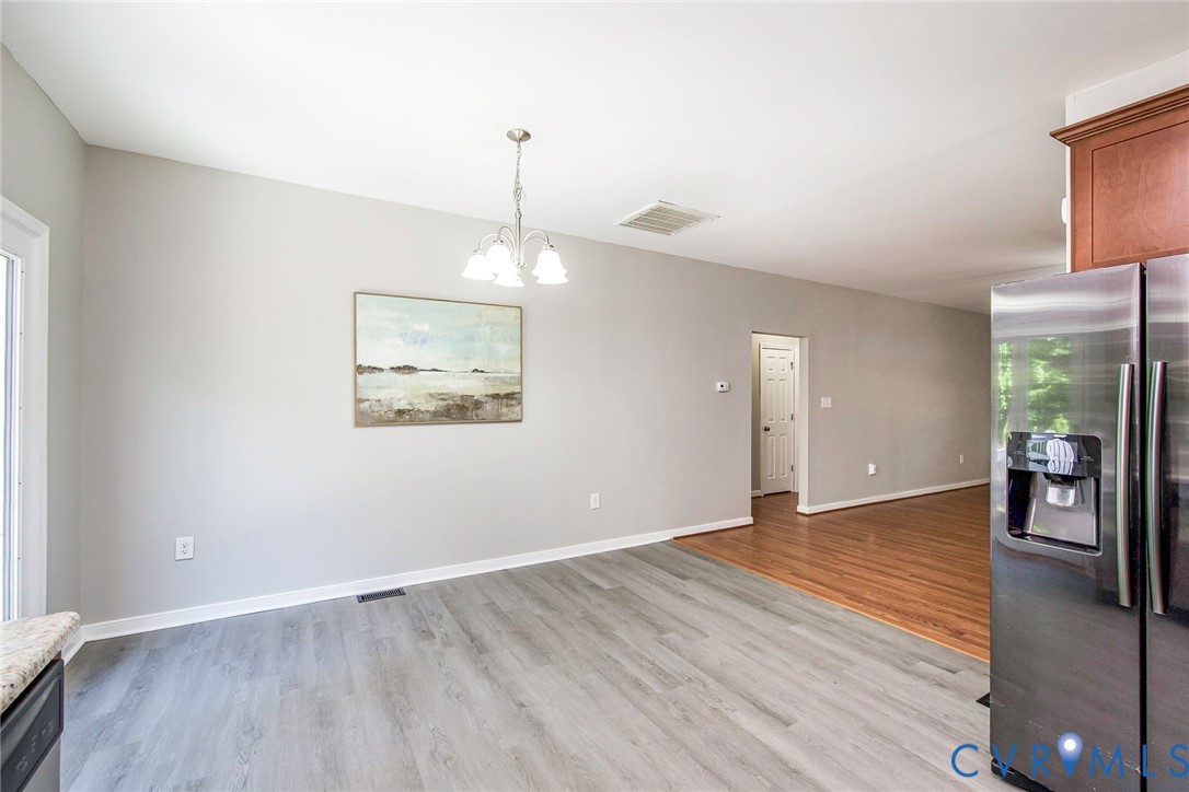 1297 Manfield Road Aylett, VA 23009 - Photo 20 of 41 a view of an empty room with window and wooden floor