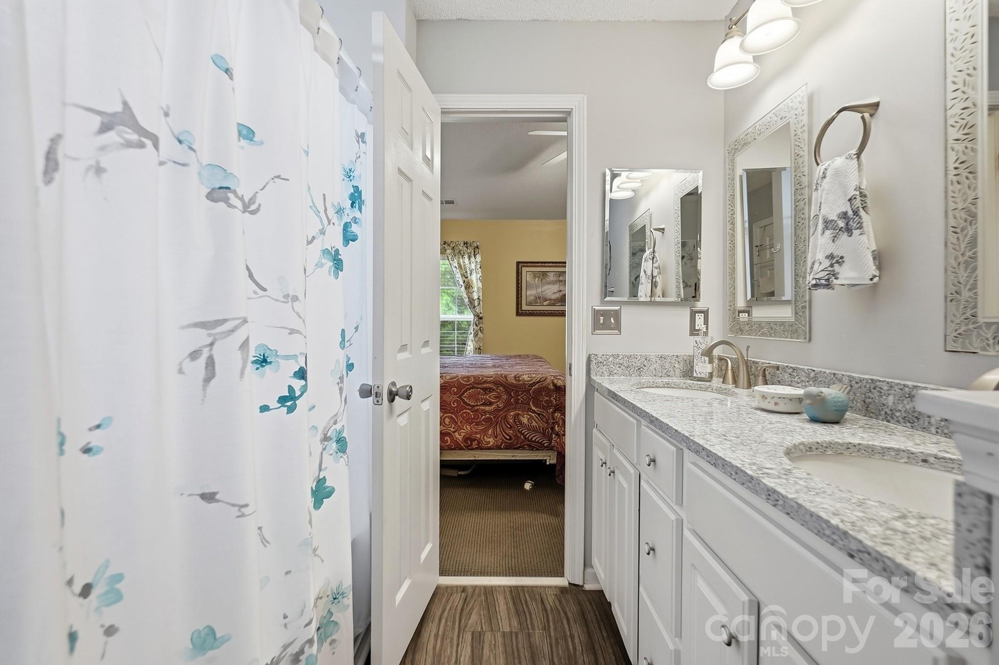 442 Sugar Maple Drive Tega Cay, SC 29708 - Photo 22 of 48 a en suite bathroom with a granite countertop sink a mirror and shower