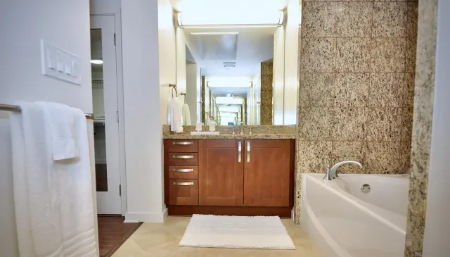 a bathroom with a bathtub a shower and a sink