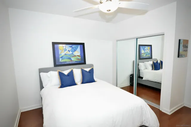 a bedroom with a large bed and a chandelier