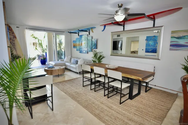 a living room with furniture a window and a potted plant