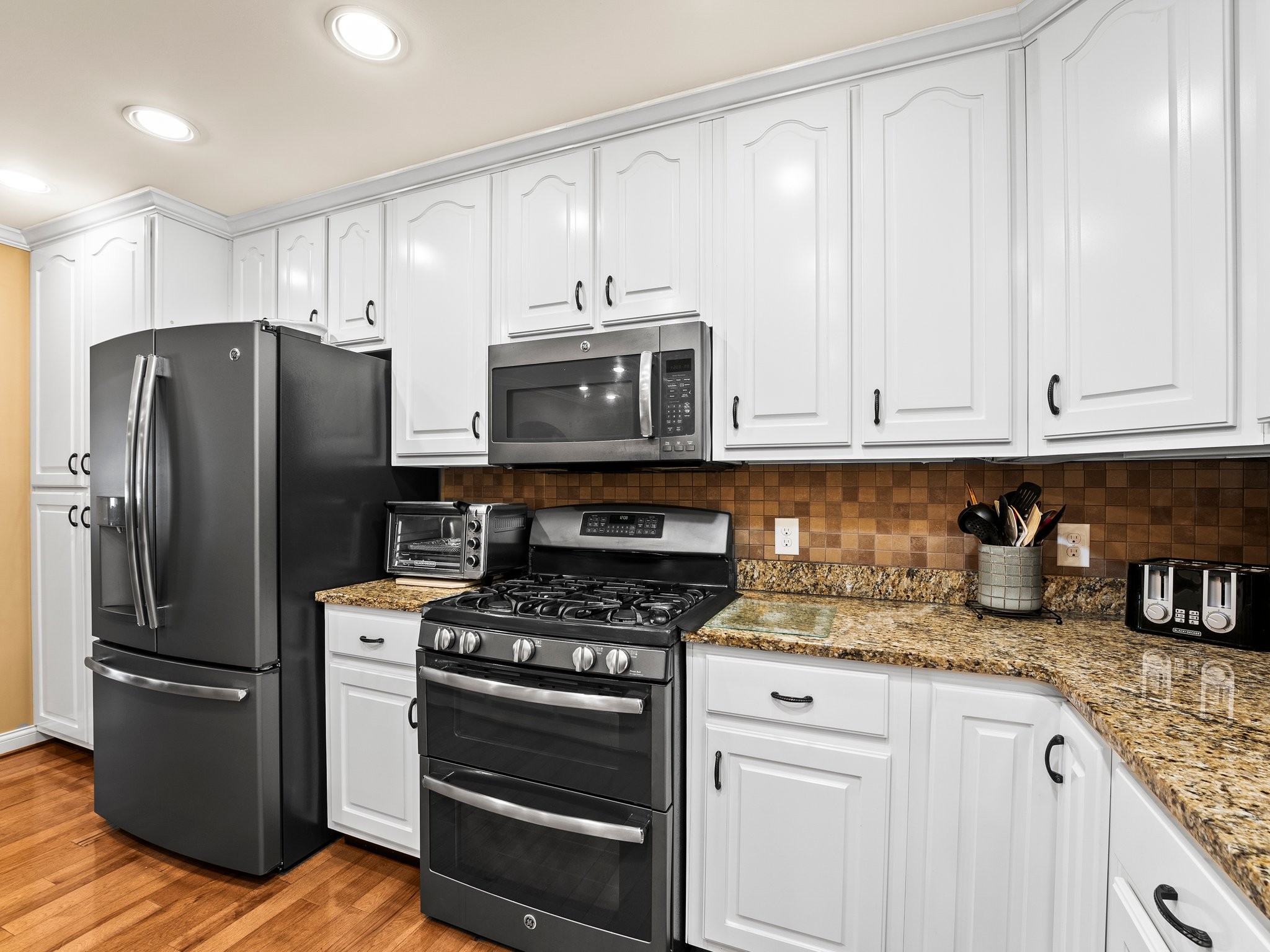 1574 Midway Road Sewanee, TN 37375 - Photo 12 of 45 a kitchen with granite countertop white cabinets and stainless steel appliances