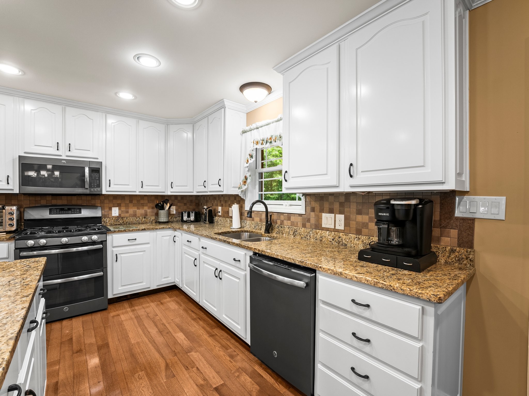 1574 Midway Road Sewanee, TN 37375 - Photo 13 of 45 a kitchen with granite countertop stainless steel appliances white cabinets granite counter tops and a hard wood floors