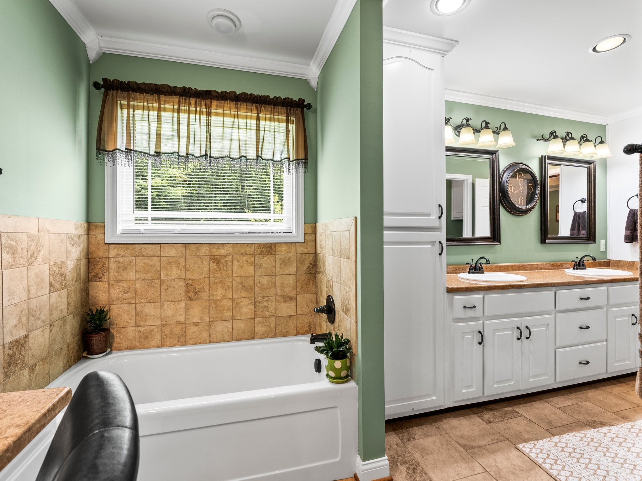 1574 Midway Road Sewanee, TN 37375 - Photo 21 of 45 a bathroom with a bathtub a sink and a large mirror