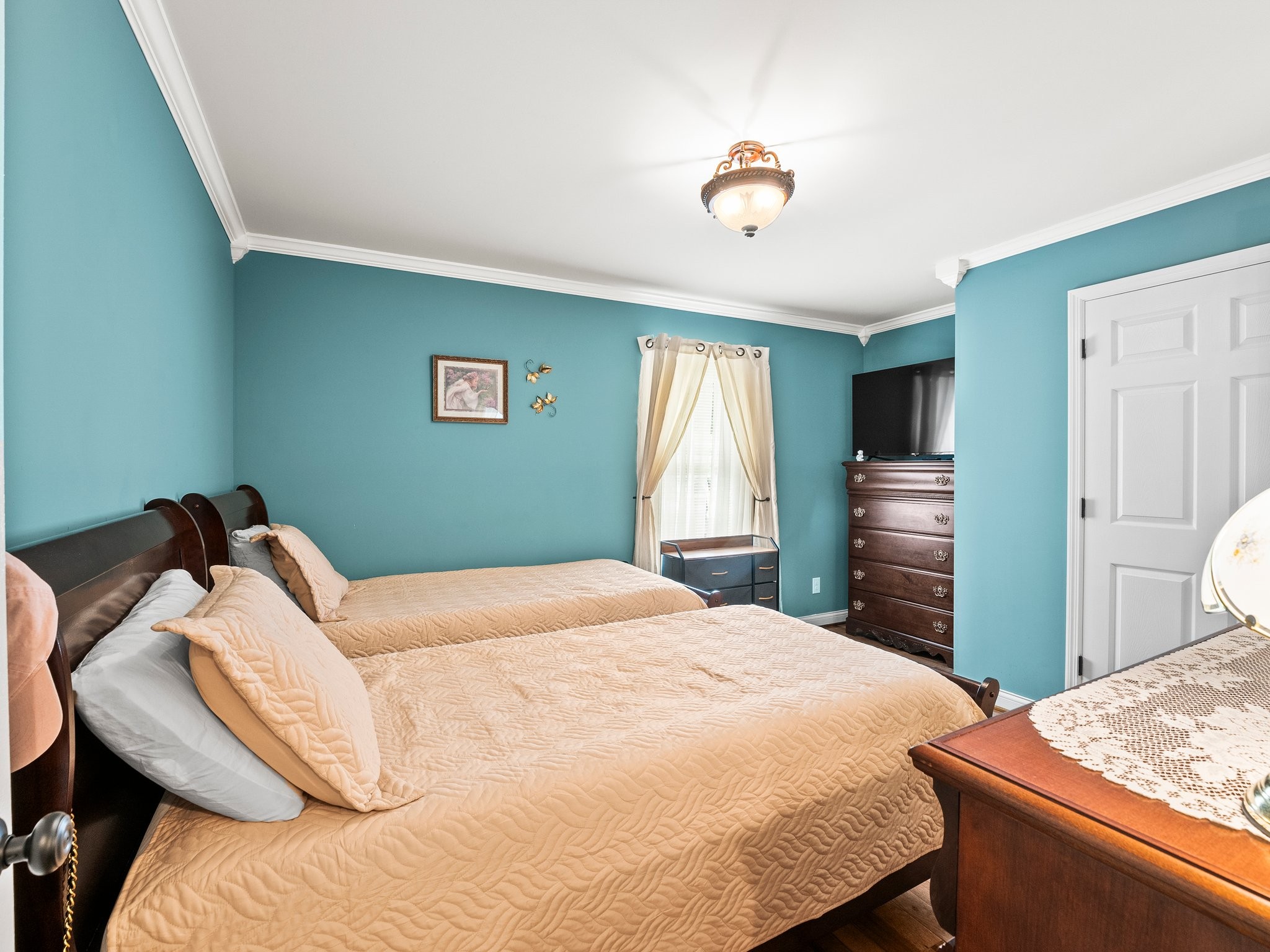 1574 Midway Road Sewanee, TN 37375 - Photo 22 of 45 a bedroom with a bed and a chandelier