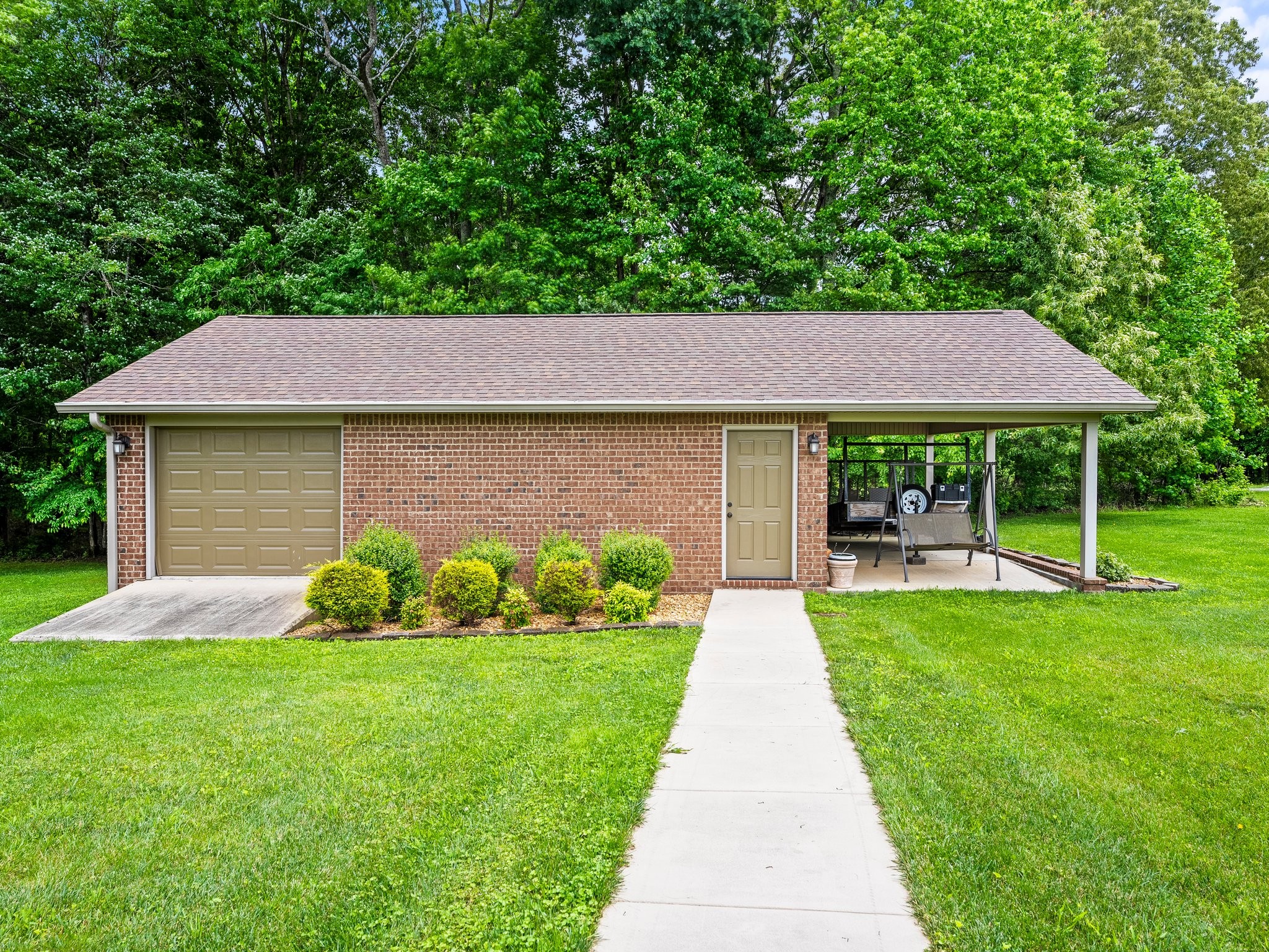1574 Midway Road Sewanee, TN 37375 - Photo 40 of 45 a front view of a house with a garden and plants