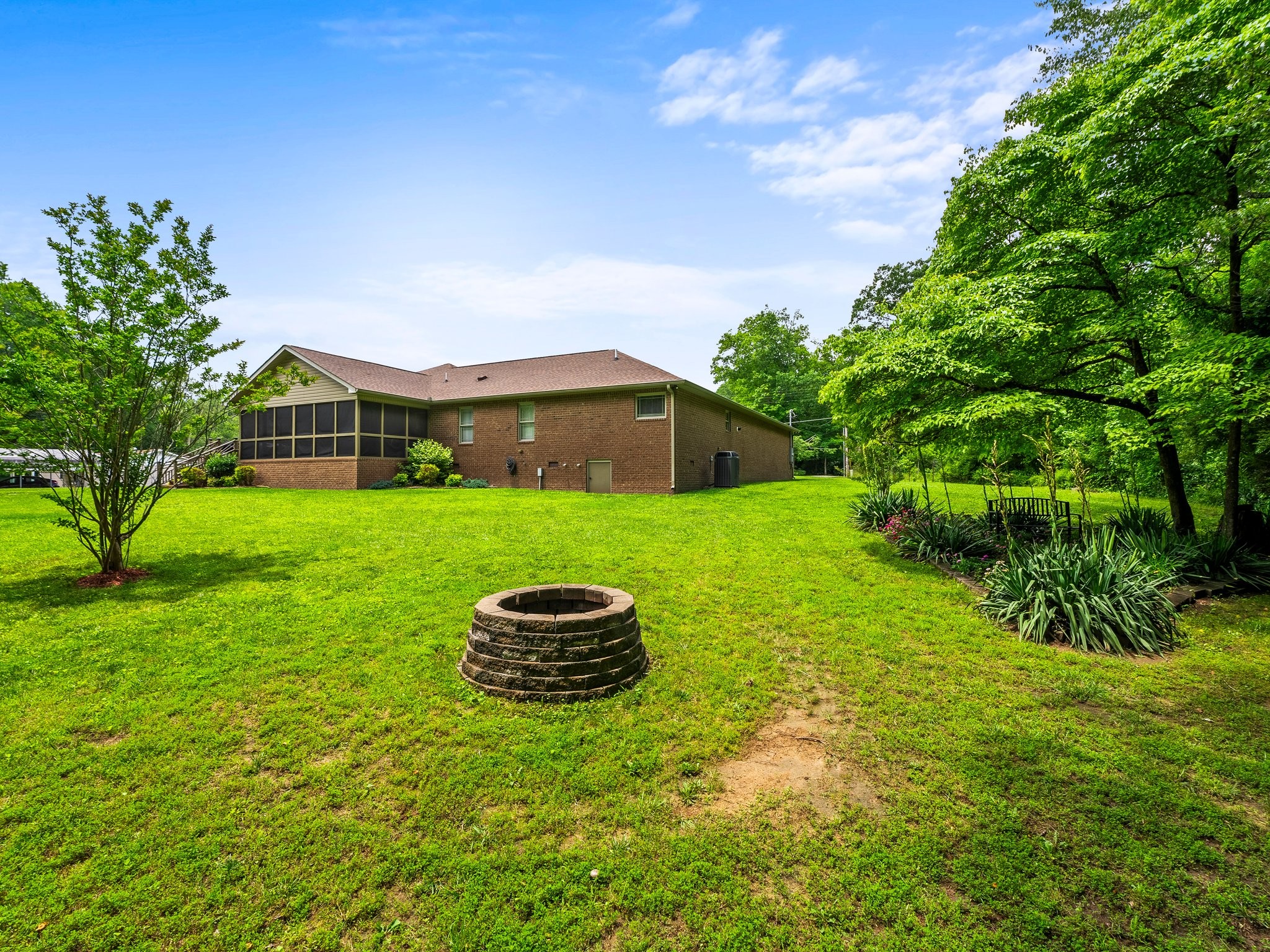1574 Midway Road Sewanee, TN 37375 - Photo 43 of 45 a backyard of a house with plants and large tree