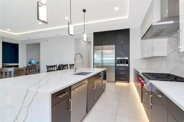 a large kitchen with kitchen island a sink stainless steel appliances and cabinets