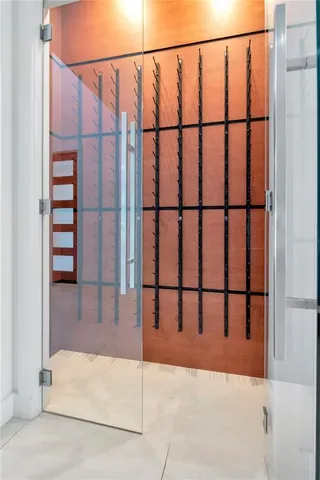 an empty room with wooden floor closet and windows