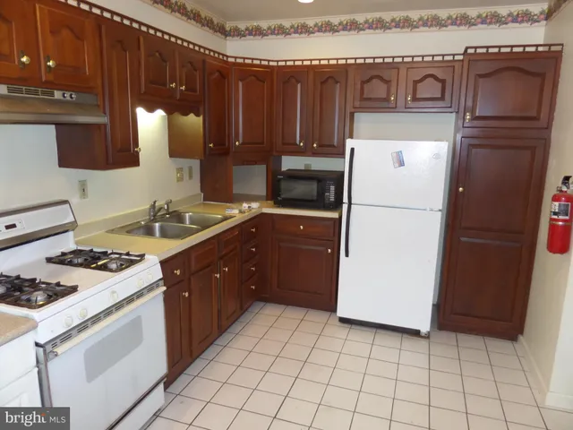 a kitchen with a stove top oven and cabinets