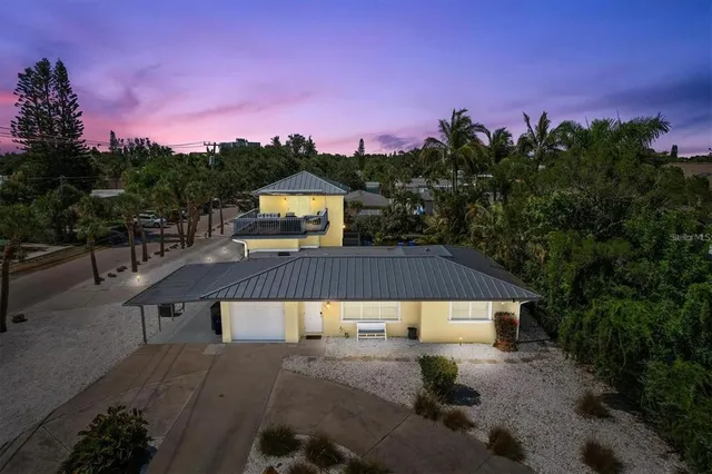 a view of a house with a yard from a patio