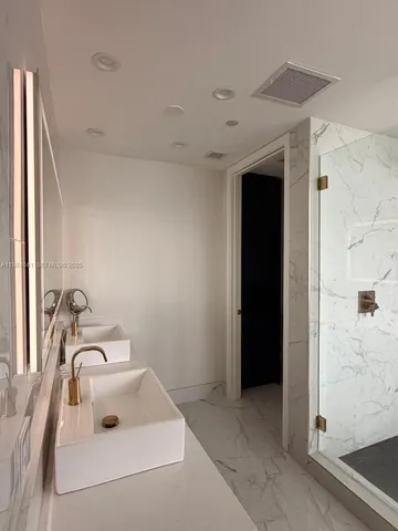 a bathroom with a sink and mirror