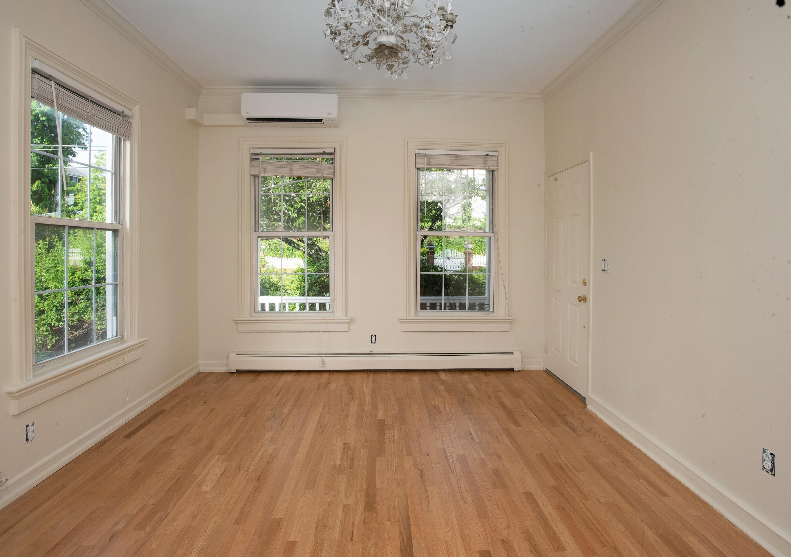 167 Park Street, Unit 1 New Canaan, CT 06840 - Photo 4 of 11 a view of an empty room with wooden floor and a window