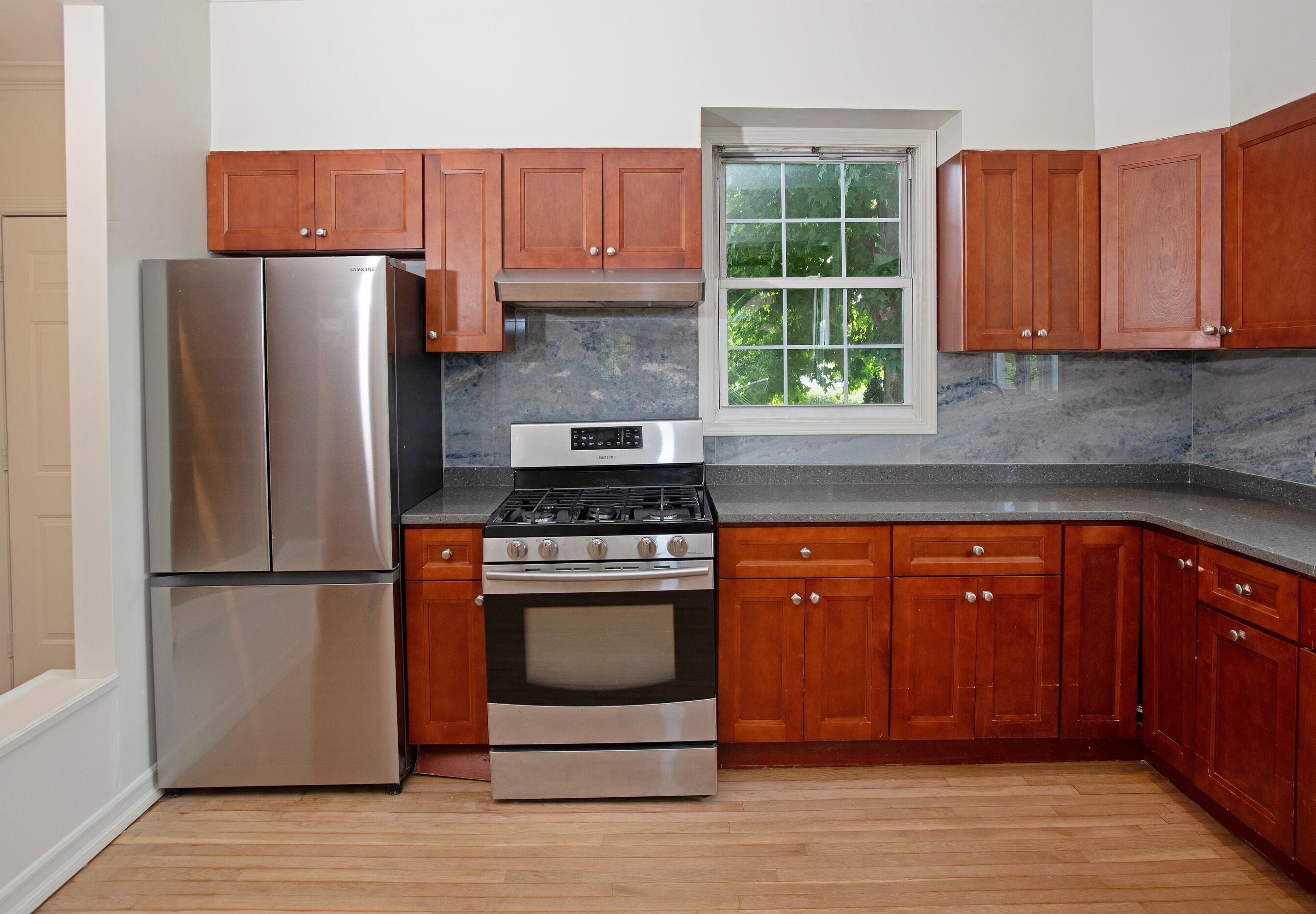 167 Park Street, Unit 1 New Canaan, CT 06840 - Photo 6 of 11 a kitchen with stainless steel appliances granite countertop a refrigerator stove and sink