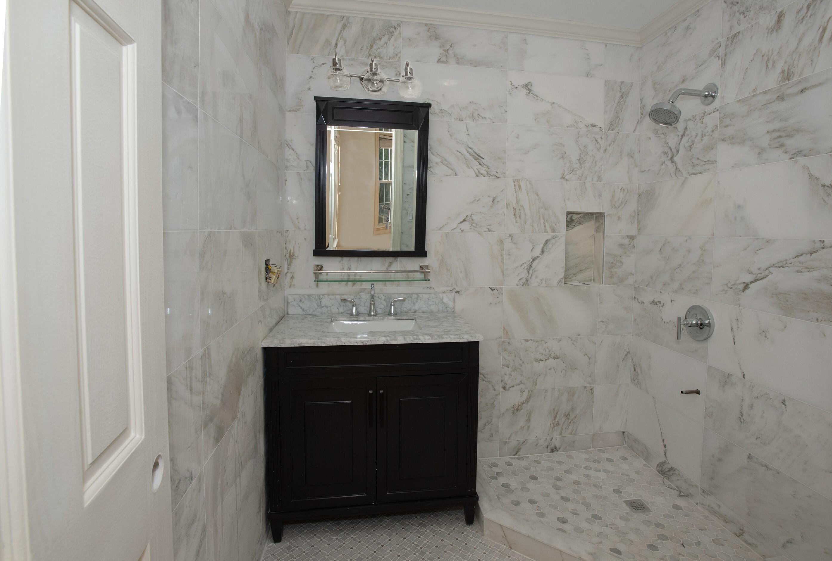 167 Park Street, Unit 1 New Canaan, CT 06840 - Photo 7 of 11 a bathroom with a sink and a mirror