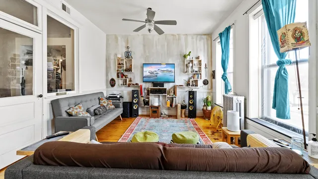 a bedroom with a bed a table and chair