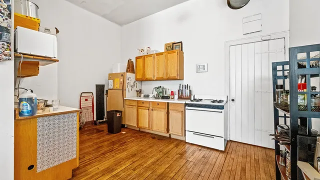 a living room with furniture and a view of kitchen