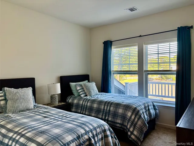 a bedroom with two beds and a large window