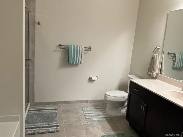 a bathroom with a sink a toilet and mirror