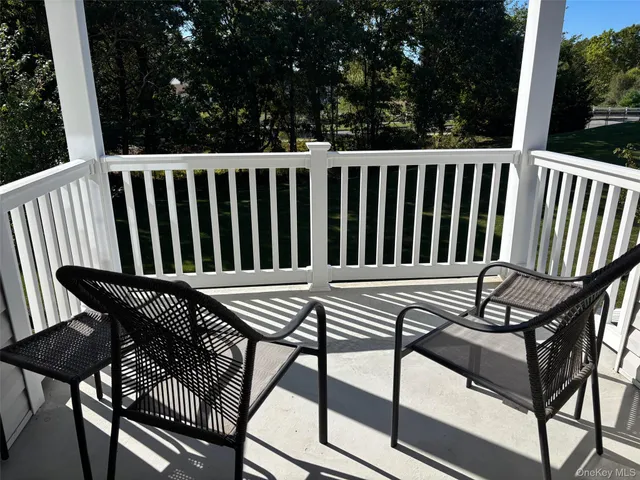 a view of a roof deck with wooden floor and fence